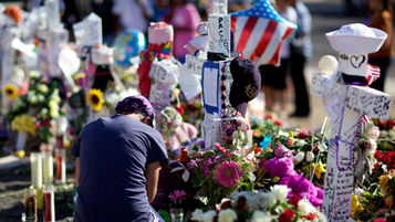 Someone mourning at a victims' memoral