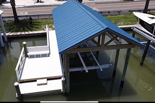 Custom dock design over the water with roof and boat loft