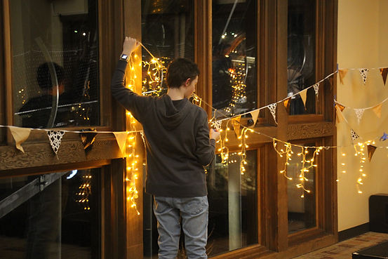 Owen Furfaro (9) helps set up for Morp by putting lights up. Photo Credit: Roselyn Robison