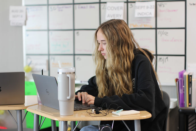 Recording the world. Mylee Hobbs (12) uses a notebook and voice recorder to listen to an interview in Publications. With phones banned in school, students are turning to other methods to complete tasks. Photo Credit: Avery Houghton