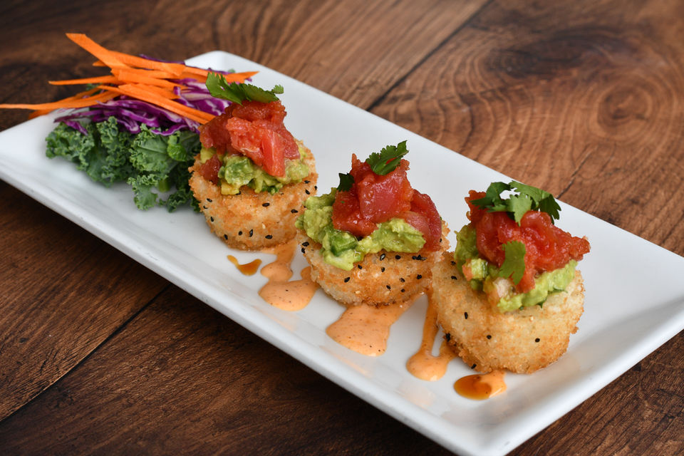 Our Spicy Tuna over Rice Crispy , a fusion of bold flavors and satisfying crunch! Experience the excitement as tender pieces of spicy tuna are expertly over a crispy shell of rice, creating a delightful contrast of textures with every bite.