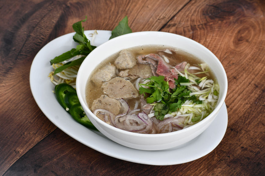 Our Beef Pho, a culinary masterpiece that captivates the senses! Savor the essence of Vietnam with tender slices of beef, thinly sliced and delicately cooked to perfection, served in a steaming bowl of fragrant broth infused with spices and herbs. 