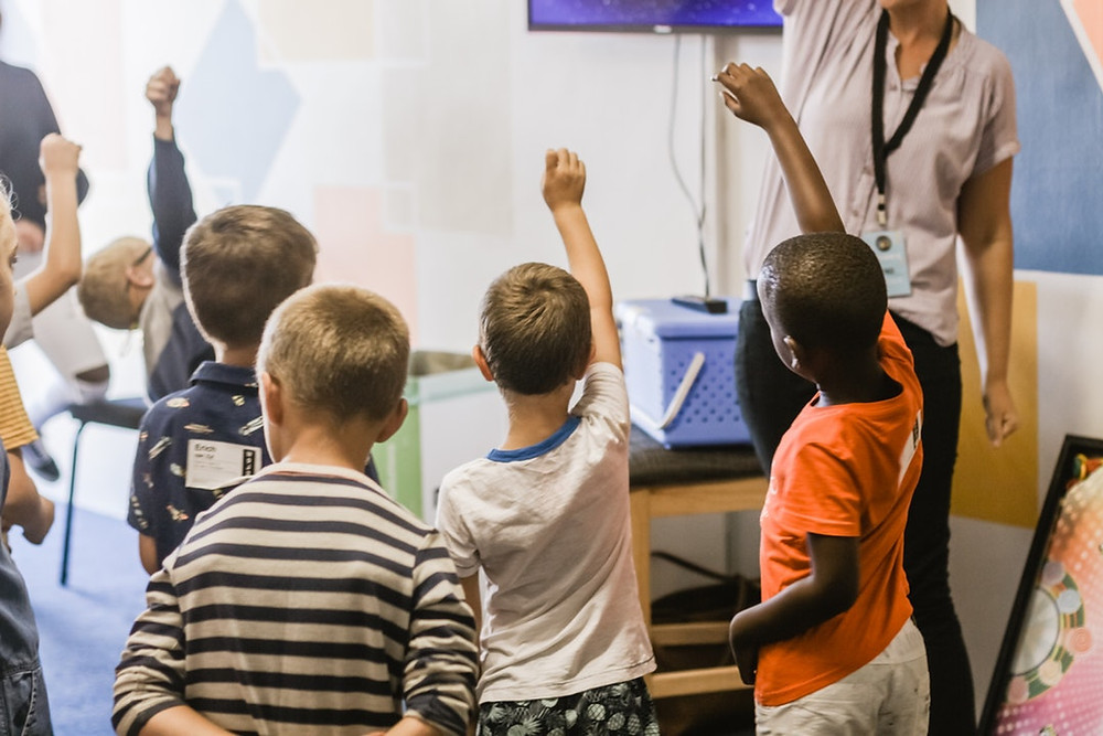 kids raising hands