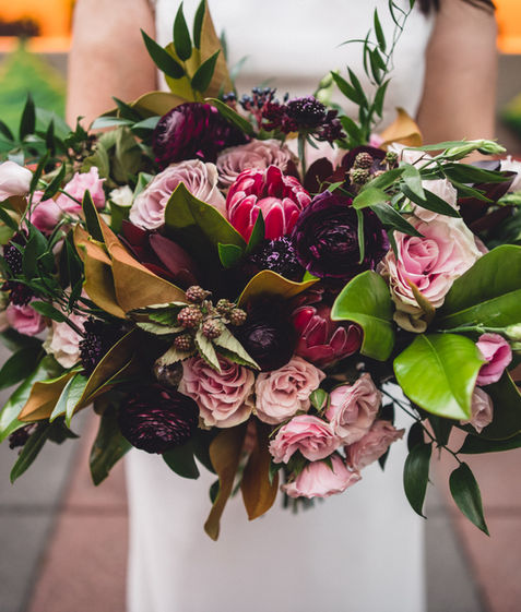 Bride holding a bouquet at MyMoon Restaurant & Event Venue, photo by Moses Cruz Photography