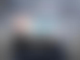 ERP project team reviewing a project charter document with timelines, scope, and objectives on a conference room screen during an implementation planning meeting