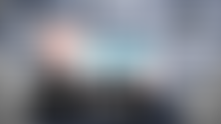 ERP project team reviewing a project charter document with timelines, scope, and objectives on a conference room screen during an implementation planning meeting