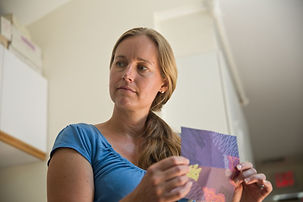 woman folding origami sheet