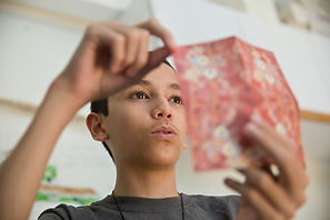 boy demonstrates origami