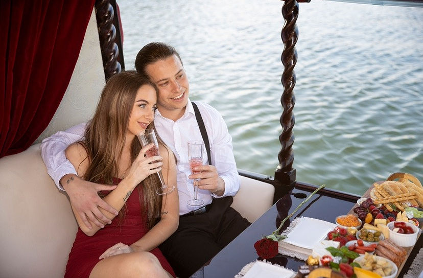 Couple drinking champagne on gondola boat