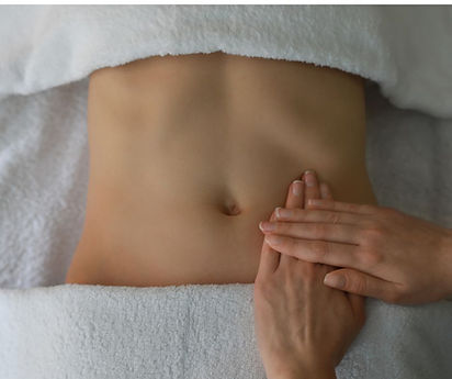 Lymphatic massage therapist performing gentle abdominal massage to help reduce post-surgical swelling and support healing in Urbandale, IA.