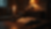 Eye-level view of a dimly lit room with a flickering candle casting shadows on a horror novel