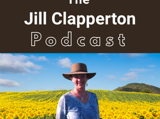 Dr. Jill Clapperton stands in a field of sunflowers
