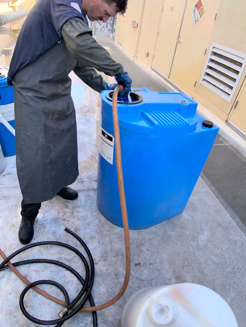 Hazmat Technician pumping contents from the chiller container.