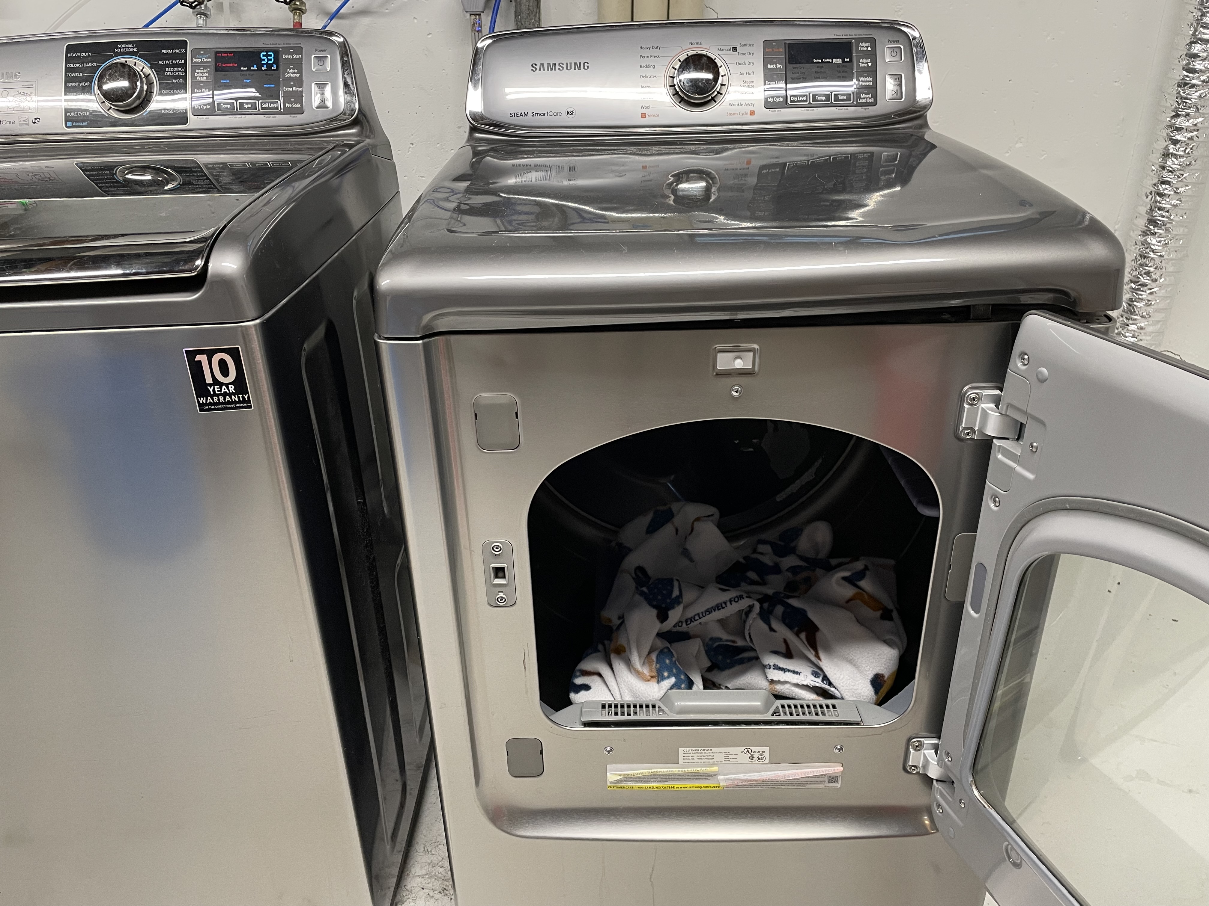 Photo of a dryer with the door open, the lint trap visible along the bottom edge.