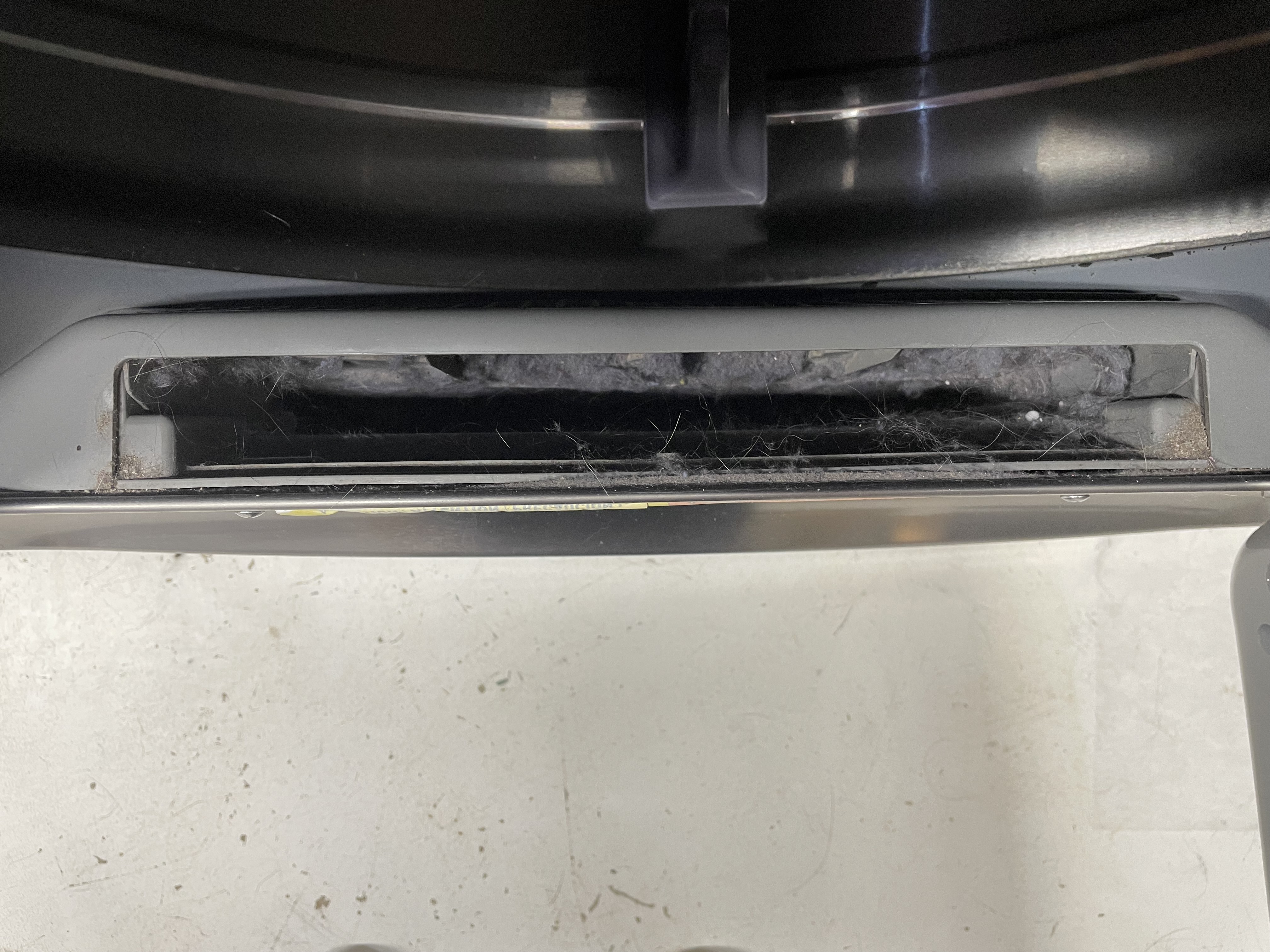 Photo of the location of the dryer lint trap where the lint trap has been removed.