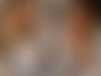 Two women sharing a coffee and each showing their yellow gold and platinum engagement rings respectively.