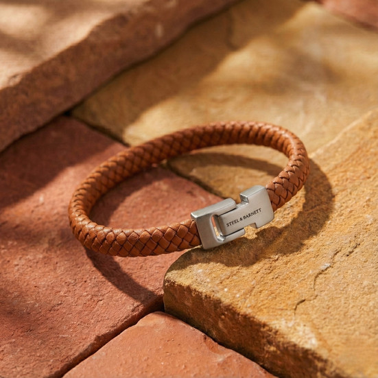 a peanut braided leather men's bracelet on a brick background