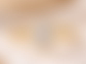 a bezel set diamond engagement ring in yellow gold on a luxury preseentation cloth