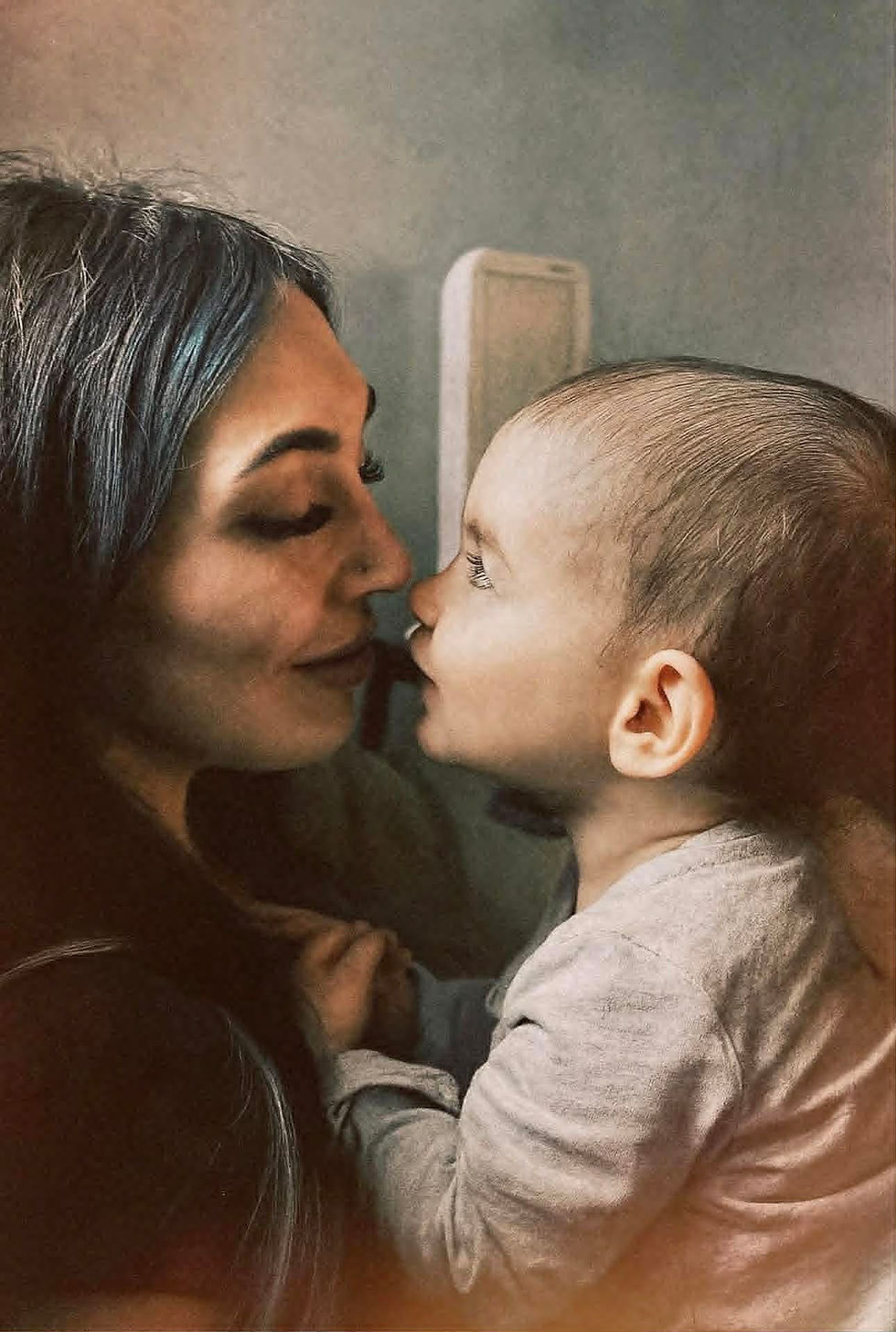 Eye-level view of a child’s hand exploring the textured surface of a tactile book