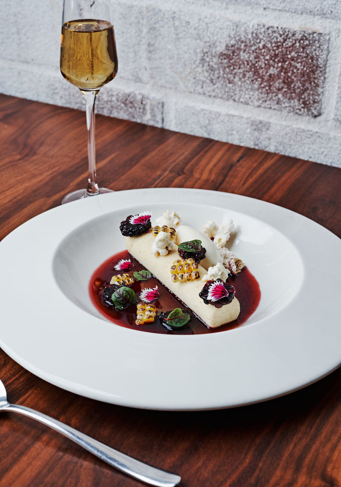 A plated course at Lazy Betty with a wine pairing.