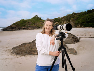 Angela Haig on beach with camera