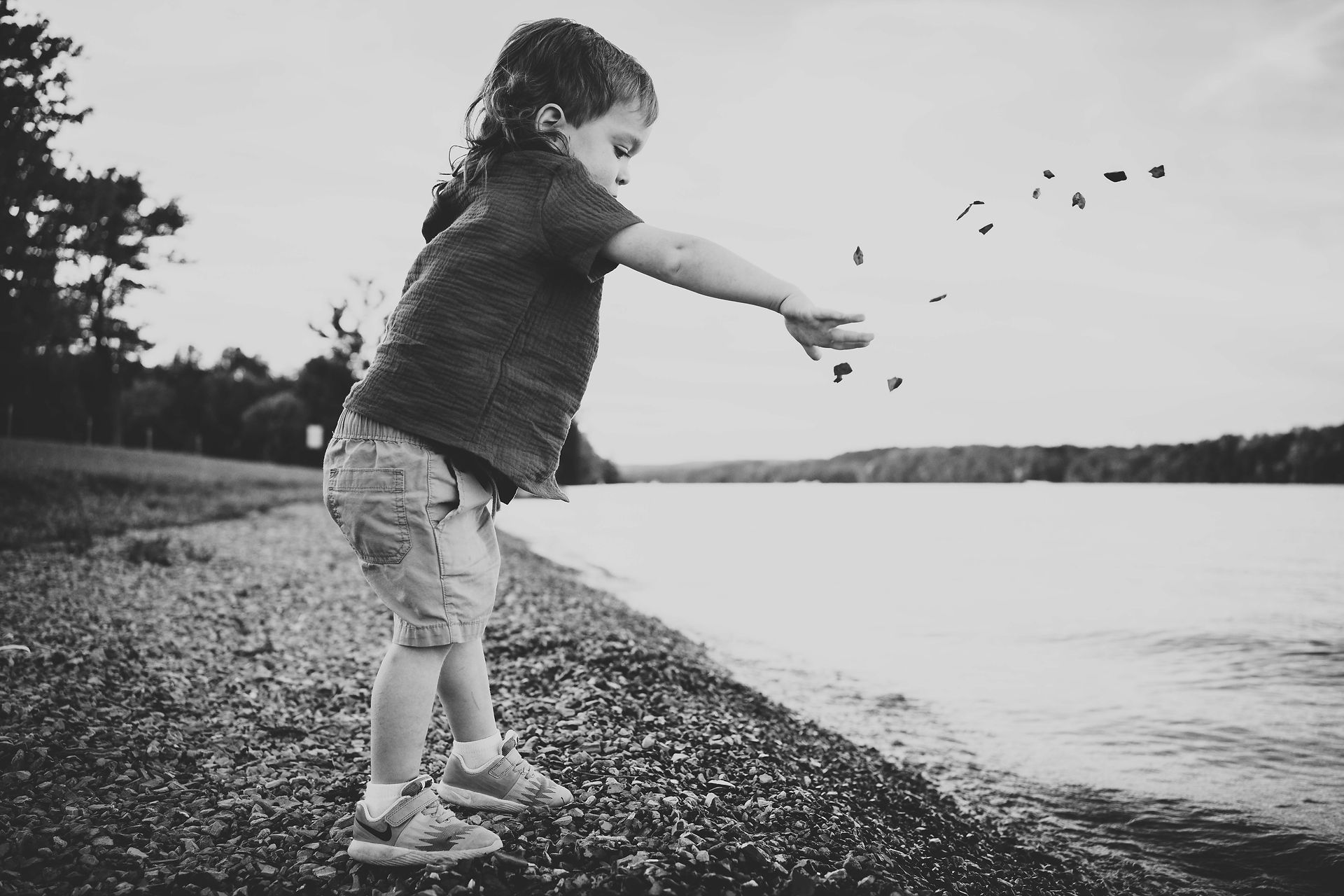 Children throwing rocks into the water at Blue Marsh Lake