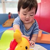Adorable baby playing in Sunflower Baby House