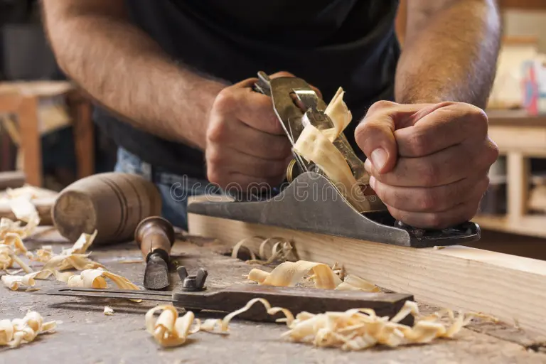 carpenter-working-plane-wooden-background-32505251.webp