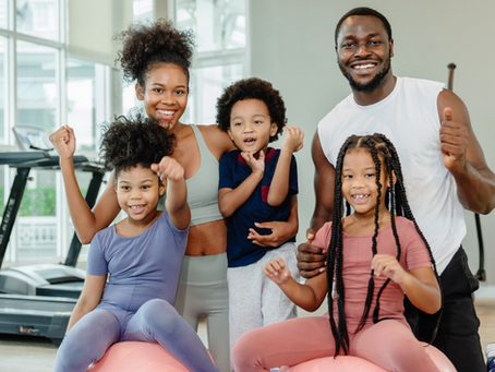 A family with 3 children being active and exercising together