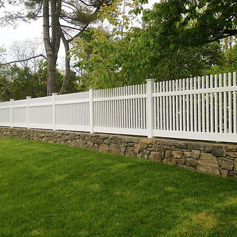An ActiveYards® fence on top of a decorative rockwall.