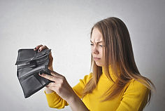 Woman looking desperatley in her wallet