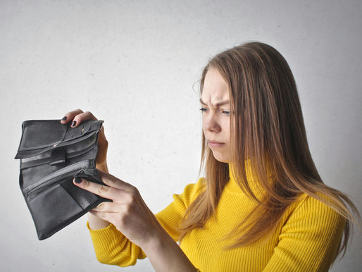 Women with frustrated expression desperatley looking in her wallet