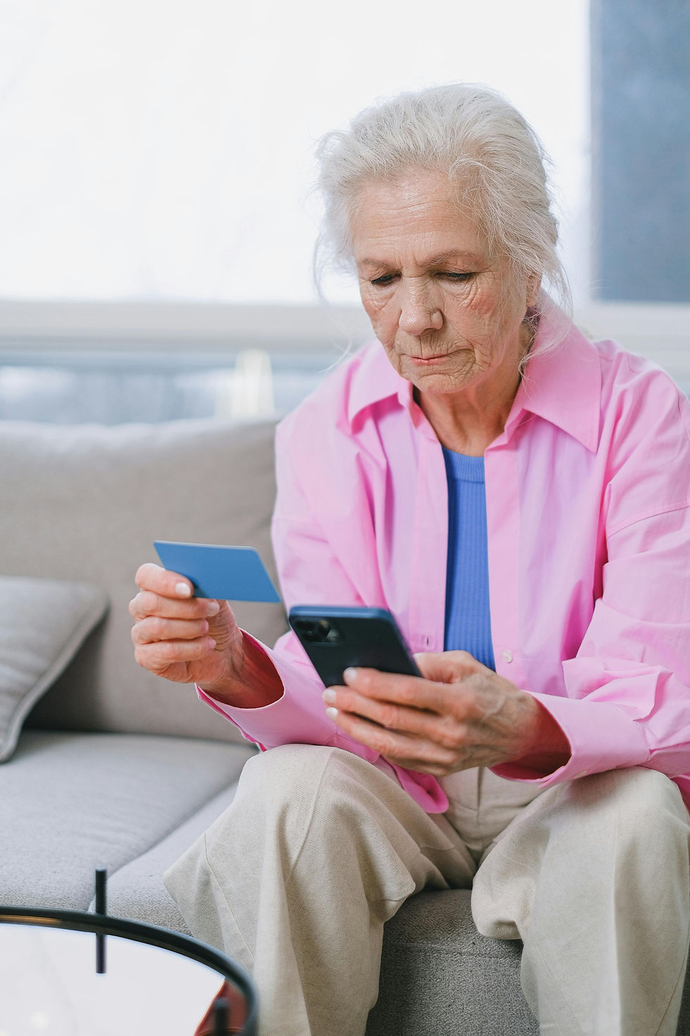 An older women holding a credit card
