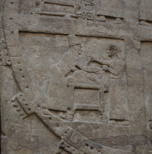 BM 124548 Fragment of the palace wall from the North West palace at Nimrud depicting extispicy