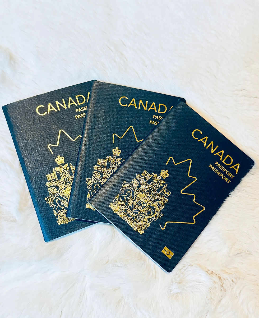Three Canadian passports arranged in a fan on a light background.