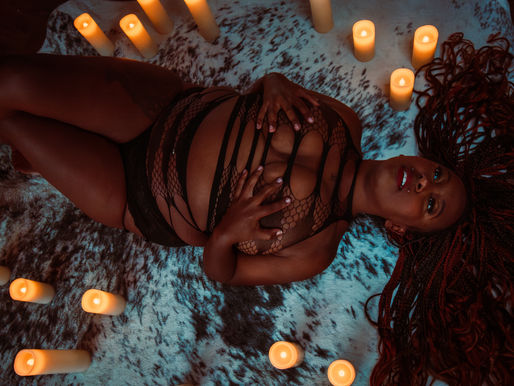 woman laying down on the floor surrounded by candles in a stunning image captured by LJ Jacobs of Luscious Rebel Intimate Artistry in Kitchener