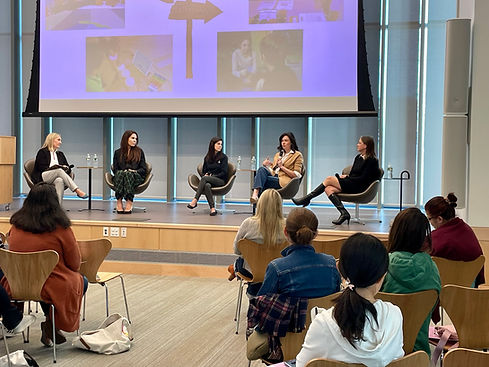 Experts sitting on a stage speaking to an audience during a workshop at New Canaan Library