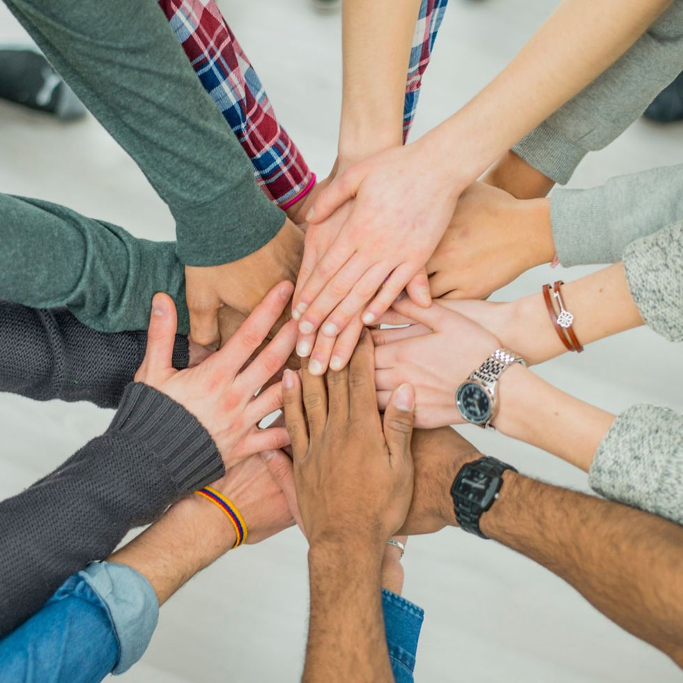 Overhead shot of several hands put together