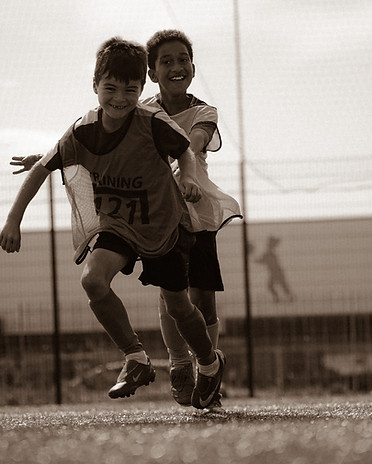 Two young boys competing in a 1v1 game with a smile on their face with Training121