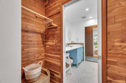 Queen bedroom with windows, closet, and connecting bathroom at Butterfly House Islamorada