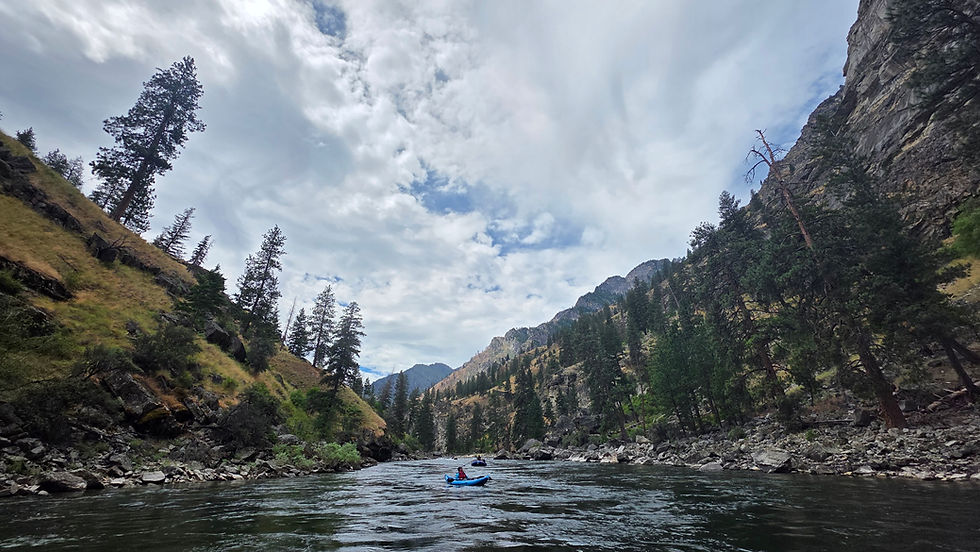 River with grassy mountains on each side