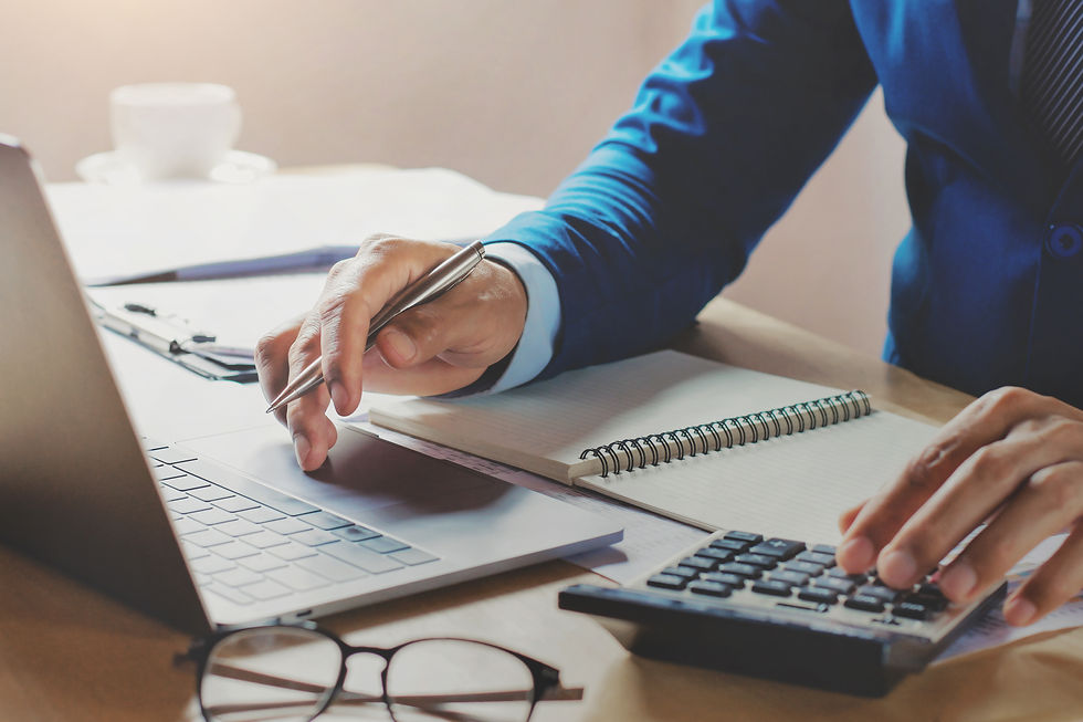 fbadvisors-accountant-working-office-using-laptop-with-calculator.jpg6