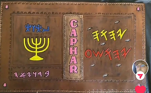 Leather-bound book with Caphar text, Yahweh symbols, and a person's video