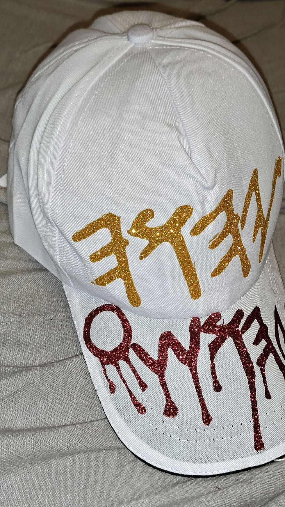 Thumbnail: White cap with Hebrew text, Cap blood of 𐤉𐤄𐤅𐤔𐤏 𐤉𐤄𐤅𐤄, Yahusto.