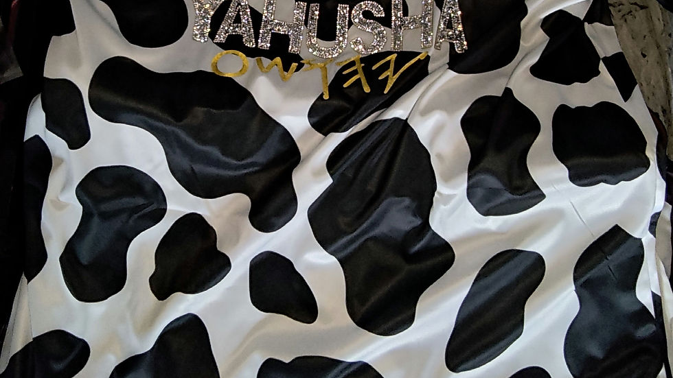 Thumbnail: White and black cow print shirt YAHLH IS ALIVE YaHU YaHUsHa bead chain. The text is visible