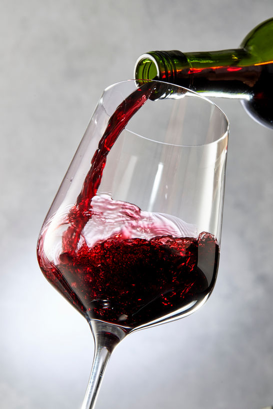 Red Wine being Poured in to a wine glass