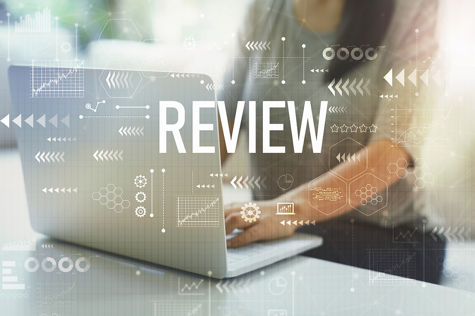 A marketer on a laptop with digital data graphics overlay and the word "REVIEW" prominently displayed, symbolizing technology-driven analysis.