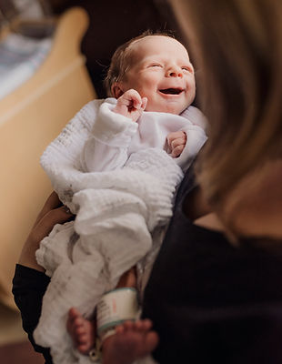 smiling baby newborn in hospital during a fresh 48 newborn photo shoot at garnet in harris new york in the sullivan county catskills