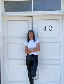Dr Anna Paxinos standing confidently outside richmond hill dental at 43 Clifton Street Richmond. boutique , personal care