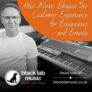 man siting at a mixing desk creating music for business